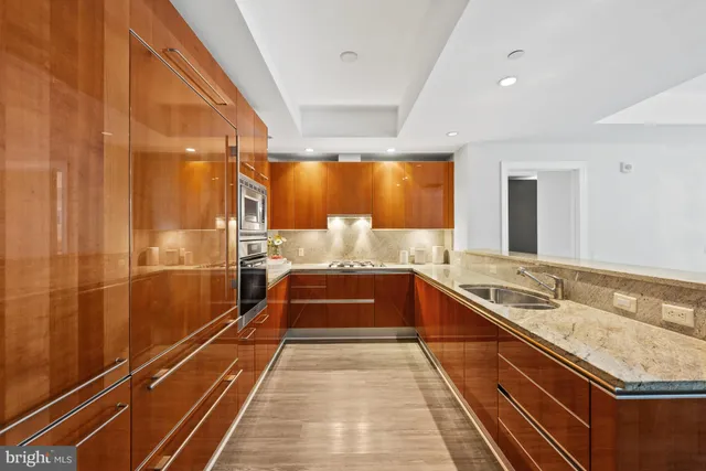 a spacious bathroom with a granite countertop sink and a large mirror