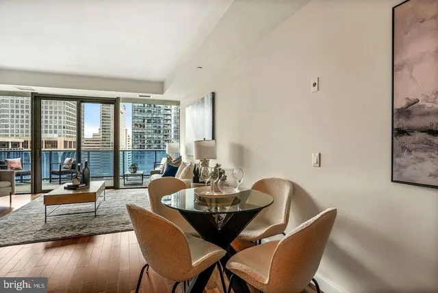 a dining room with furniture and large windows