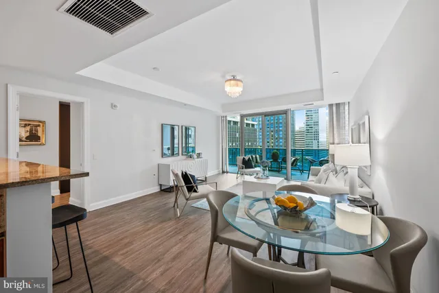 a dining room with furniture a rug and wooden floor
