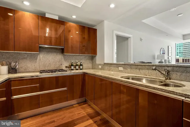 a kitchen with a sink and wooden floor