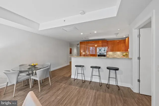 a dining room with furniture and wooden floor