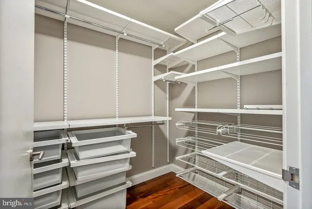 a view of walk in closet with empty racks