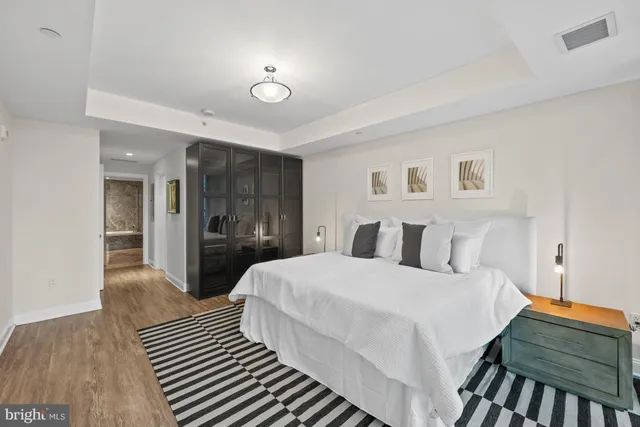 a bedroom with a bed and a chandelier