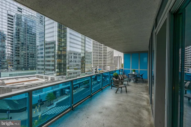 a balcony with chairs and table