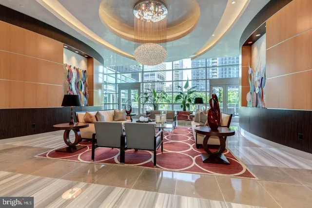 a living room with furniture a lamp and a large window