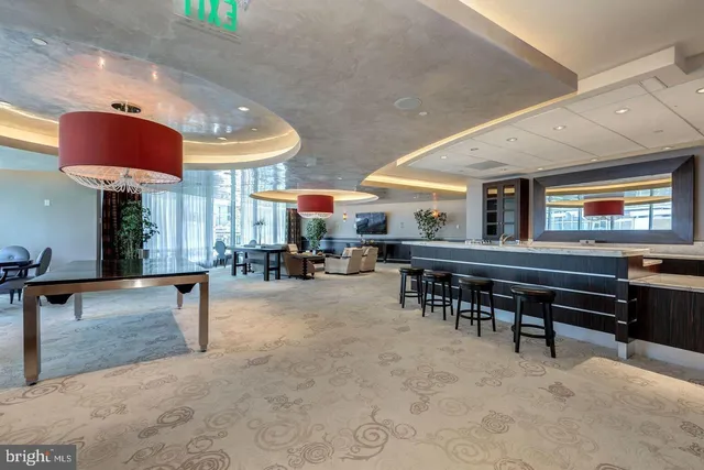an open kitchen with stainless steel appliances dining table and chairs