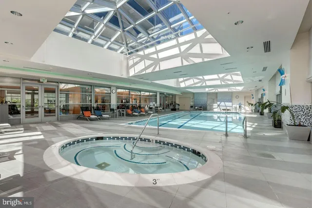 a view of a swimming pool with outdoor seating