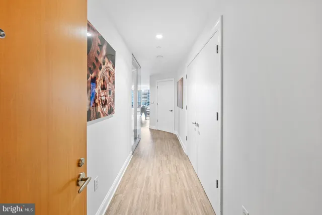 a view of a hallway with wooden floor and staircase