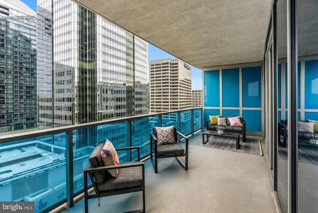 a balcony with furniture and a potted plant