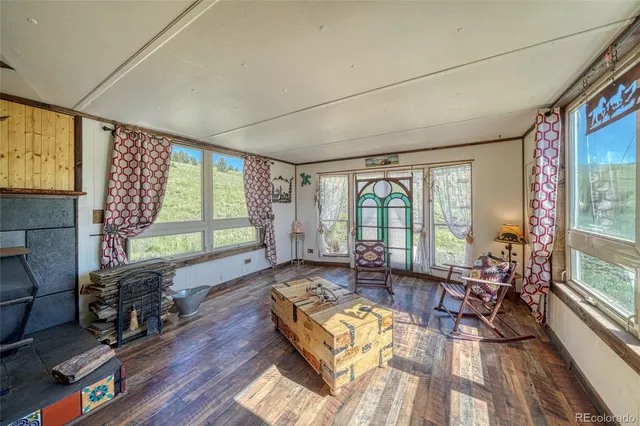 a bed sitting in a spacious bedroom next to a window