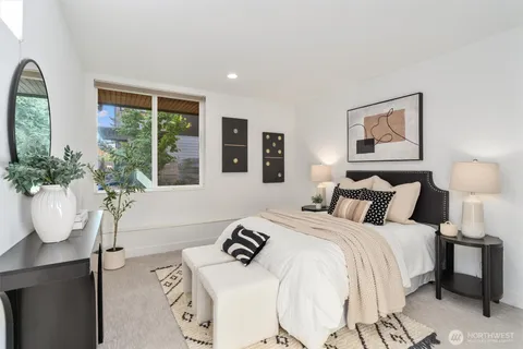 a bedroom with bed and windows