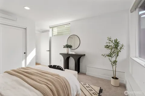a bedroom with bed and a potted plant