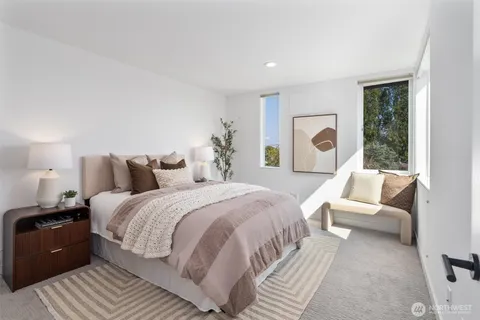 a spacious bedroom with a bed and glass window