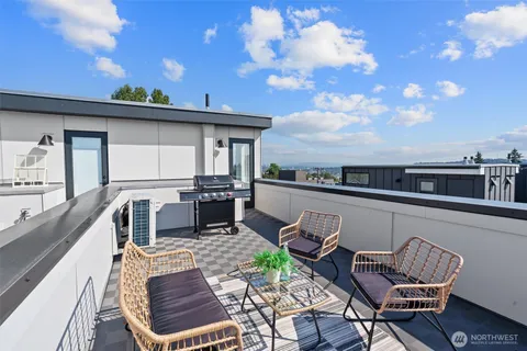 a view of a terrace with furniture and stove