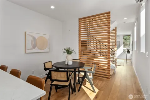 a view of a dining room with furniture and wooden floor