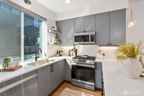 a kitchen with a sink stove and microwave