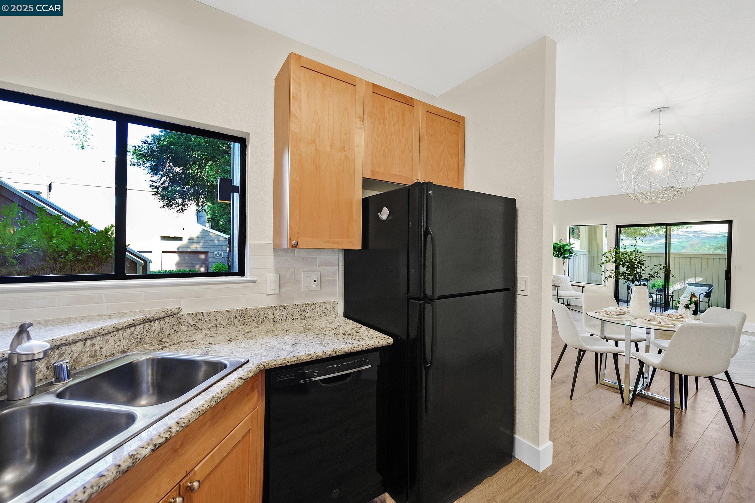 246 Copper Ridge Road San Ramon, CA 94582 - Photo 9 of 41 a kitchen with a refrigerator and a sink