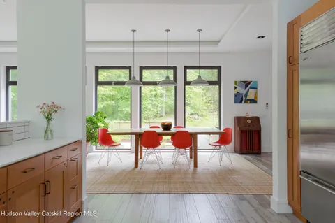 a living room with furniture and large windows