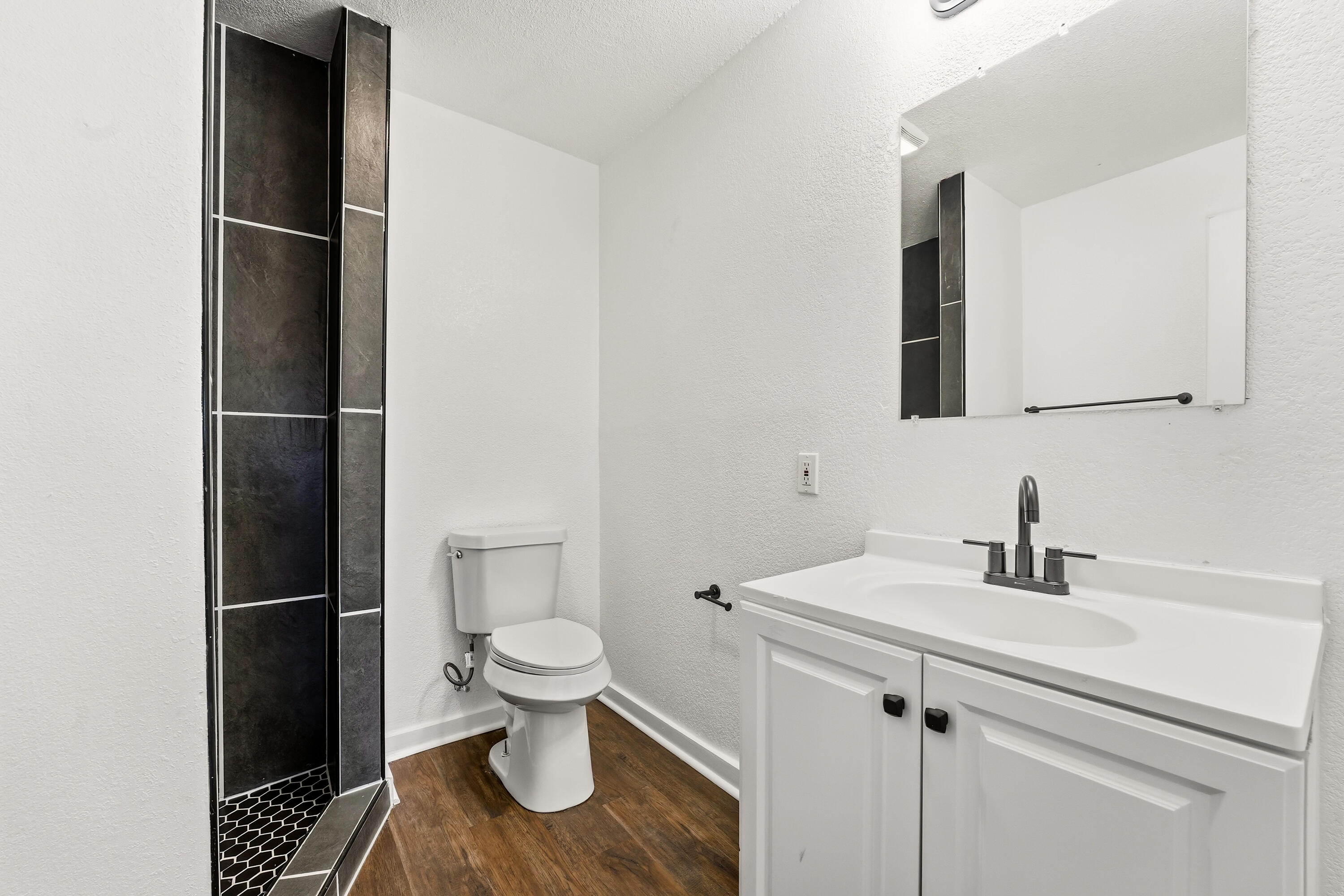 5015 16th Street Lubbock, TX 79416 - Photo 12 of 27 a bathroom with a sink toilet and shower