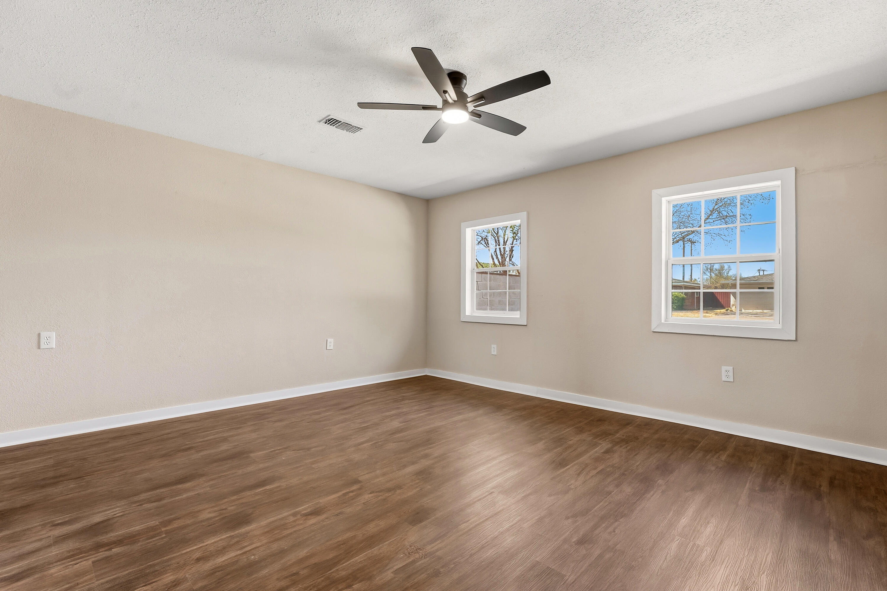 5015 16th Street Lubbock, TX 79416 - Photo 13 of 27 wooden floor in an empty room with a window