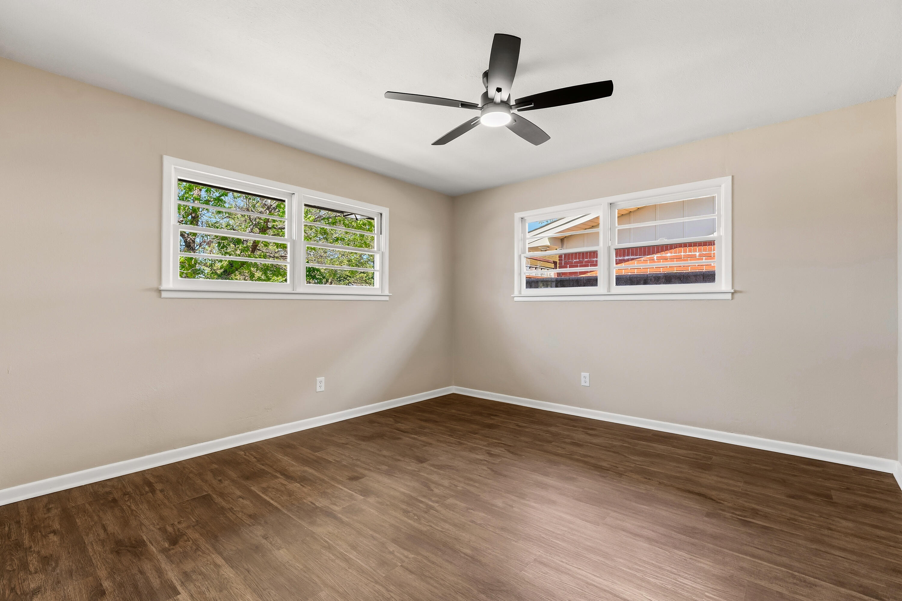5015 16th Street Lubbock, TX 79416 - Photo 17 of 27 a view of room with wooden floor ceiling fan and windows