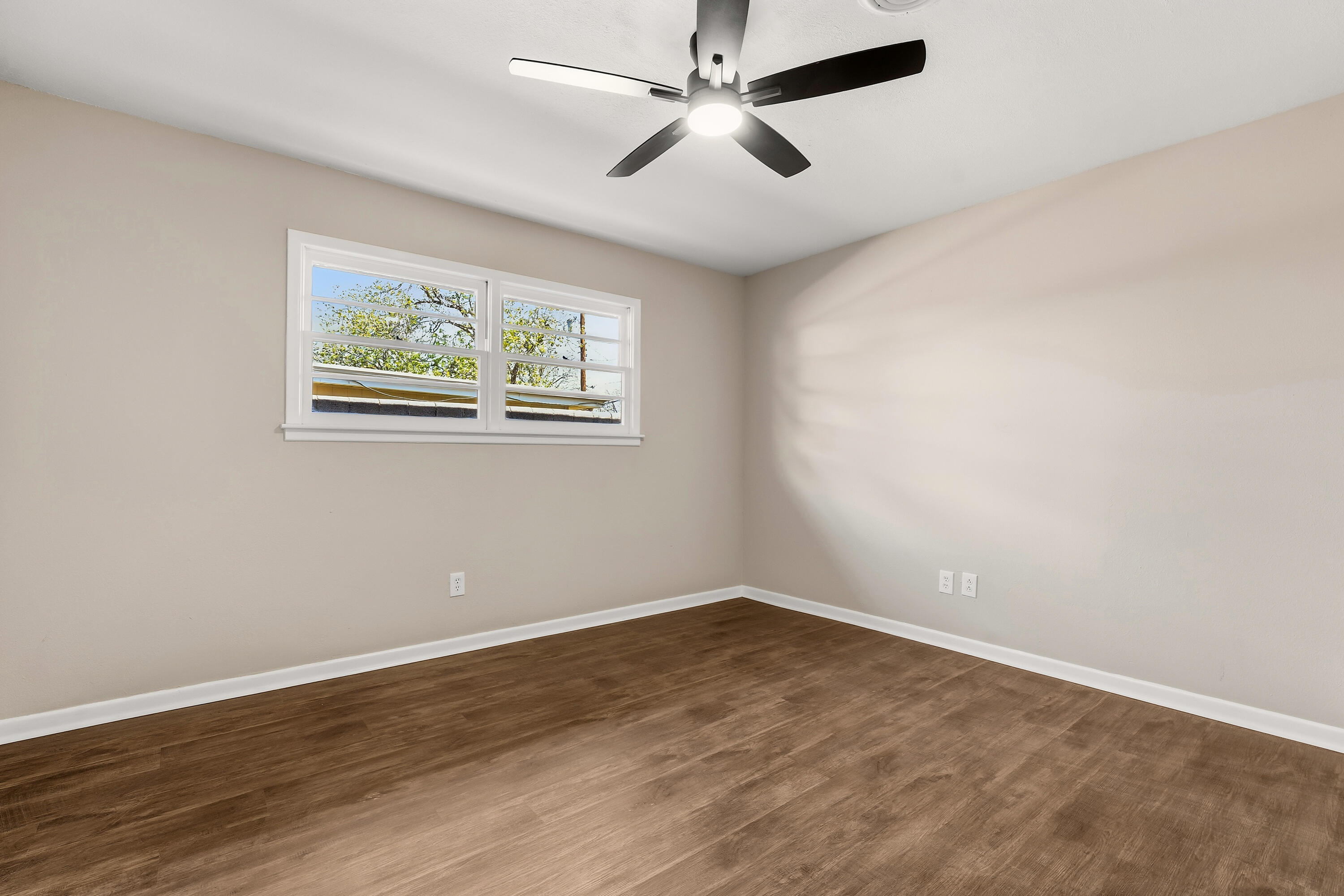 5015 16th Street Lubbock, TX 79416 - Photo 20 of 27 an empty room with wooden floor and ceiling fan
