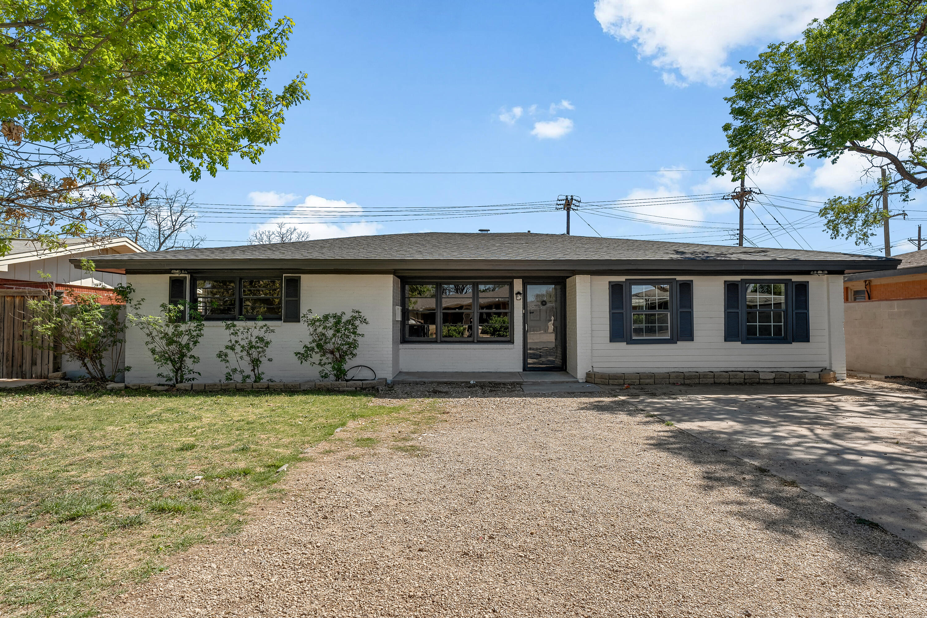 5015 16th Street Lubbock, TX 79416 - Photo 2 of 27 a front view of a house with a garden