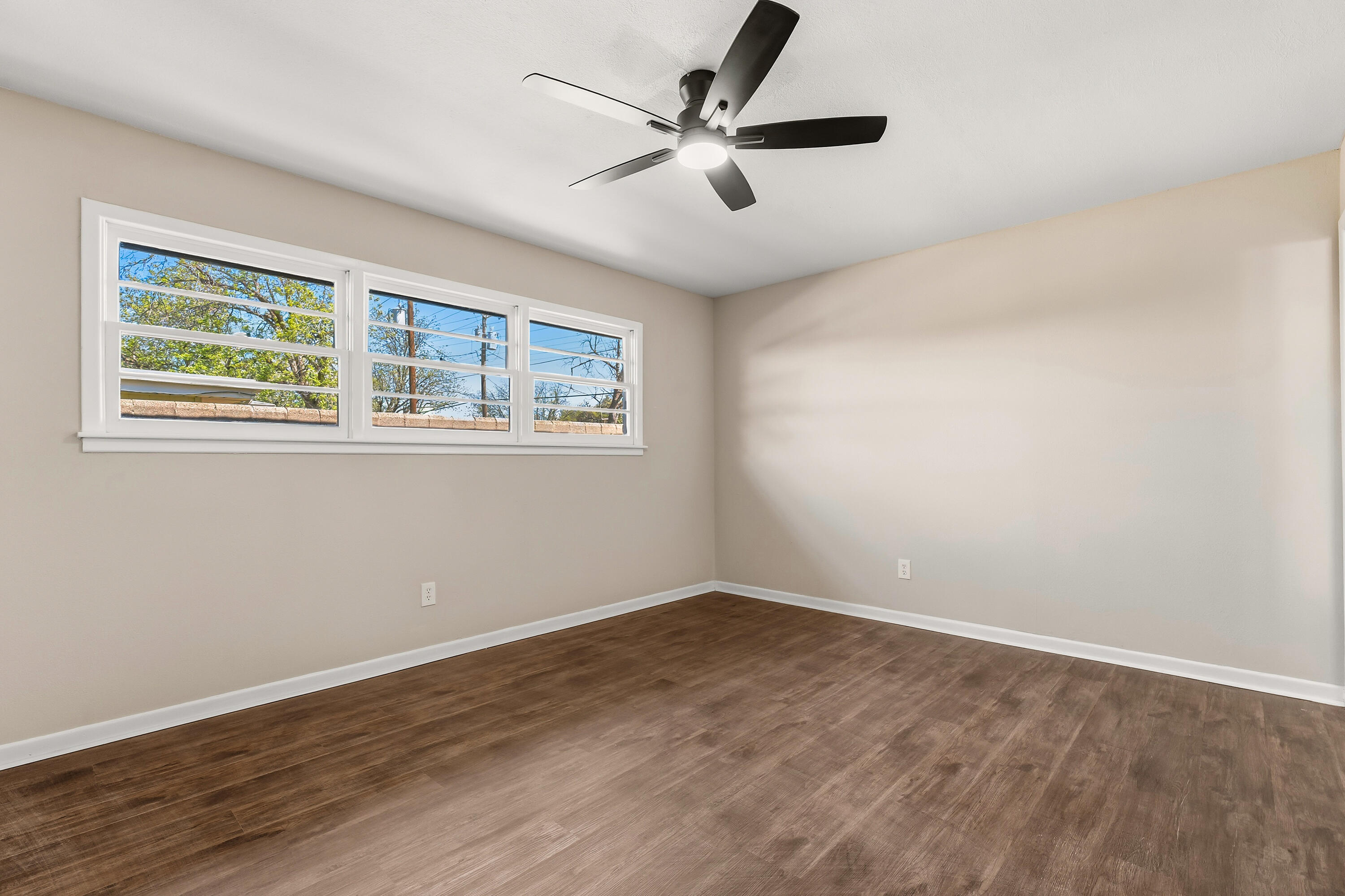 5015 16th Street Lubbock, TX 79416 - Photo 22 of 27 a view of an empty room with wooden floor and a window