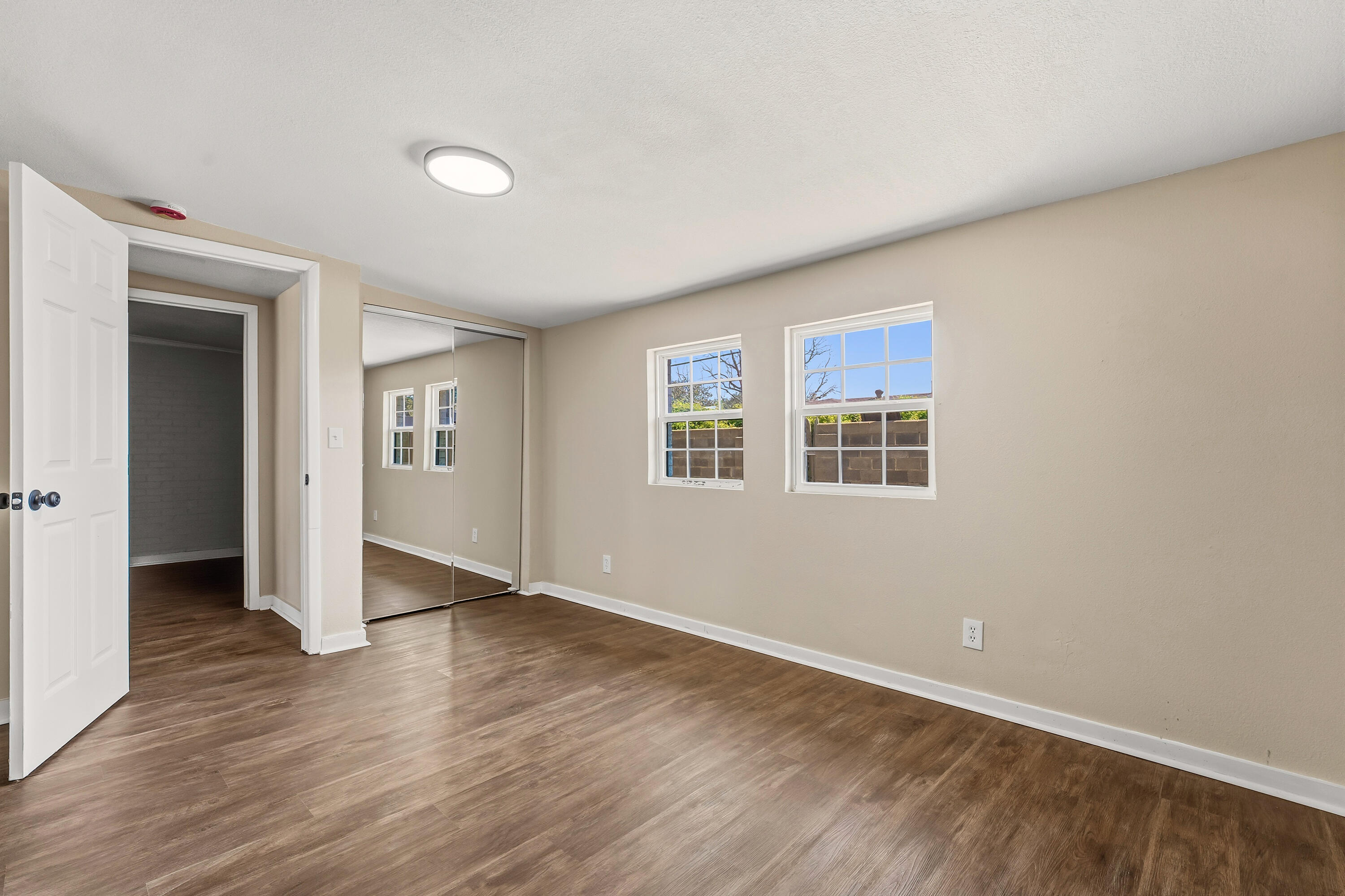 5015 16th Street Lubbock, TX 79416 - Photo 23 of 27 a view of an empty room with wooden floor and a window