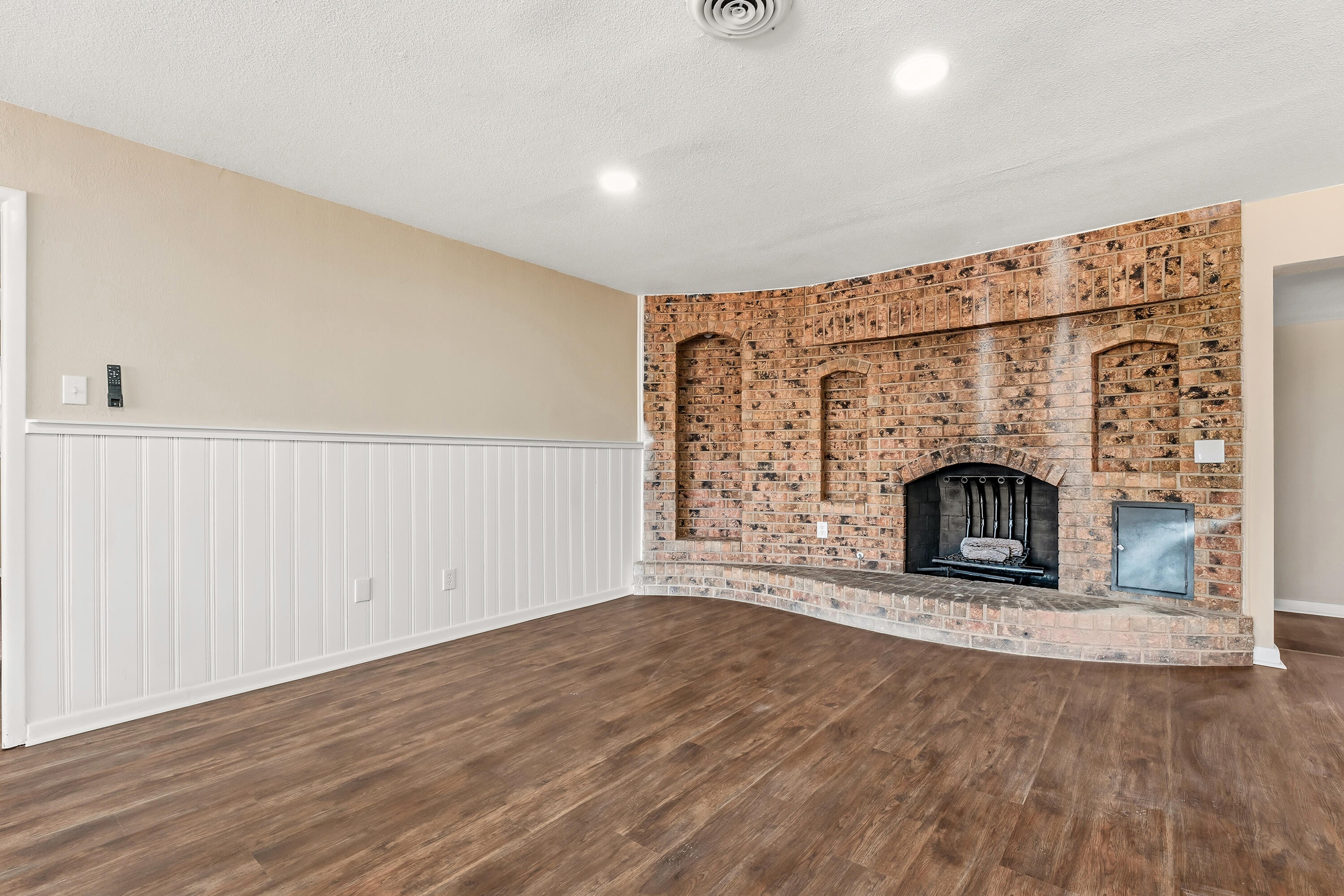5015 16th Street Lubbock, TX 79416 - Photo 8 of 27 a view of empty room with fireplace and wooden floor