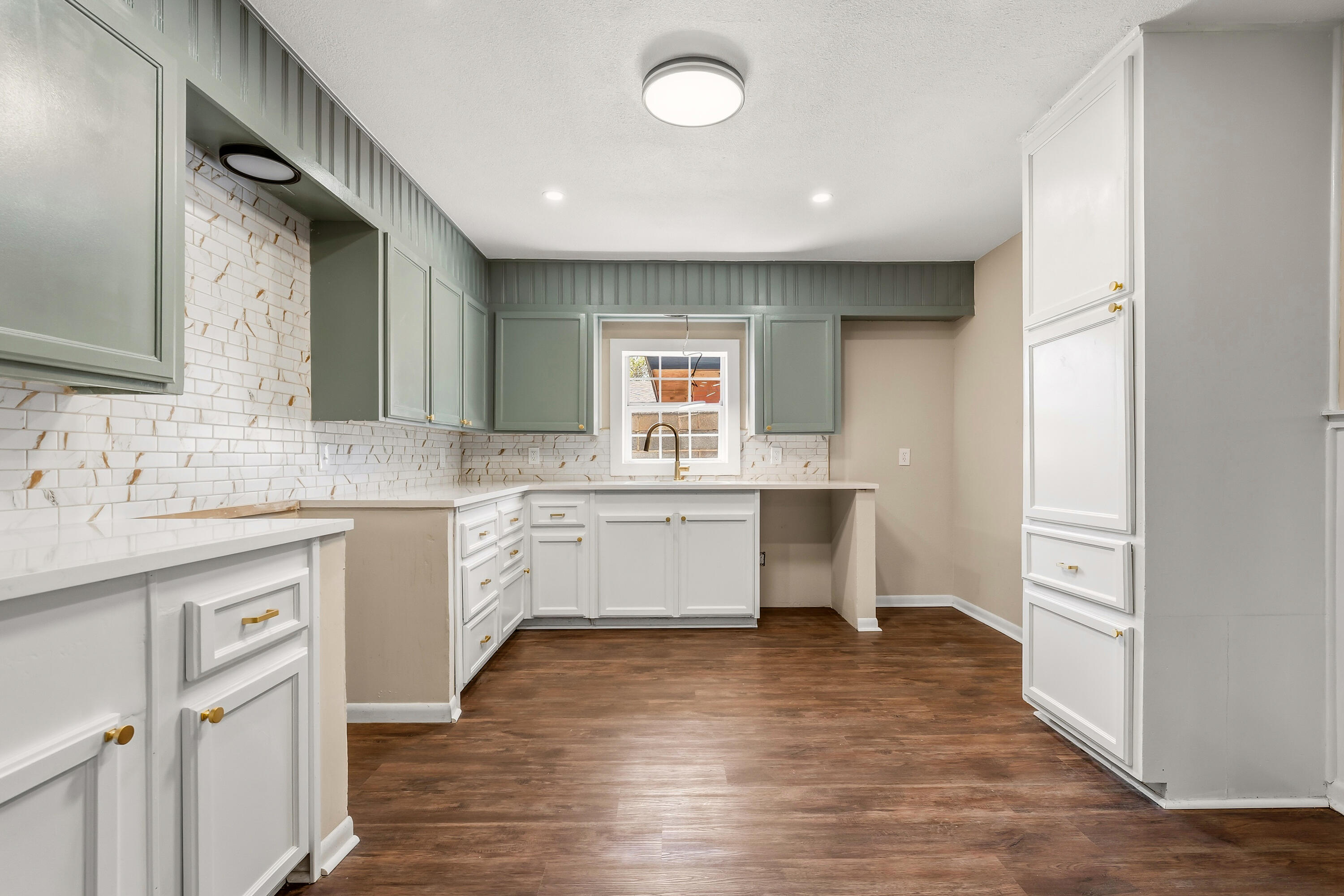 5015 16th Street Lubbock, TX 79416 - Photo 9 of 27 a kitchen with a sink stove and cabinets