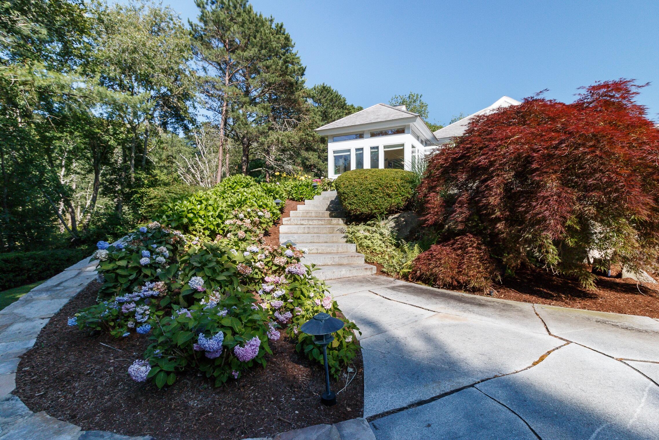 125 Greensward Road Mashpee, MA 02649 - Photo 23 of 60 a view of a garden with a pathway