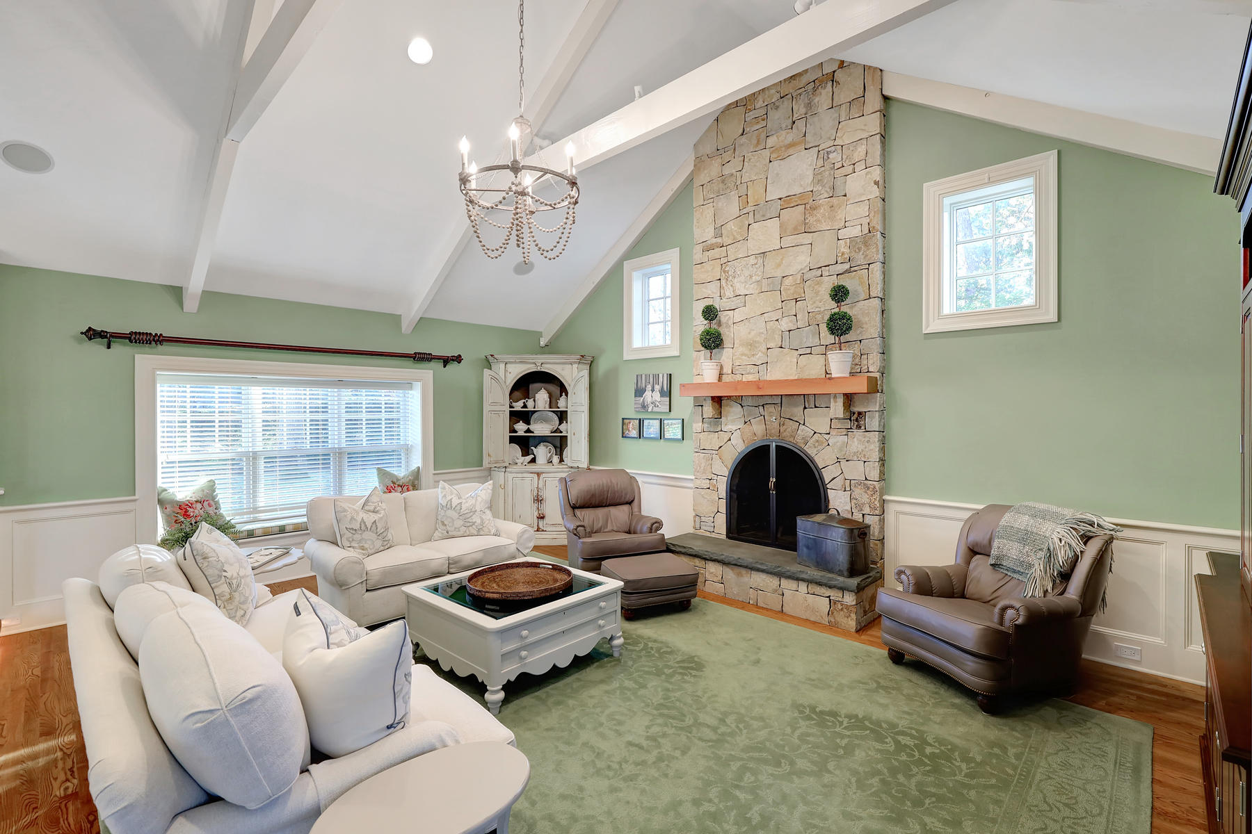 125 Greensward Road Mashpee, MA 02649 - Photo 36 of 60 a living room with furniture large window and fireplace