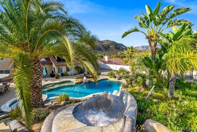 a living room with furniture a flat screen tv and a window
