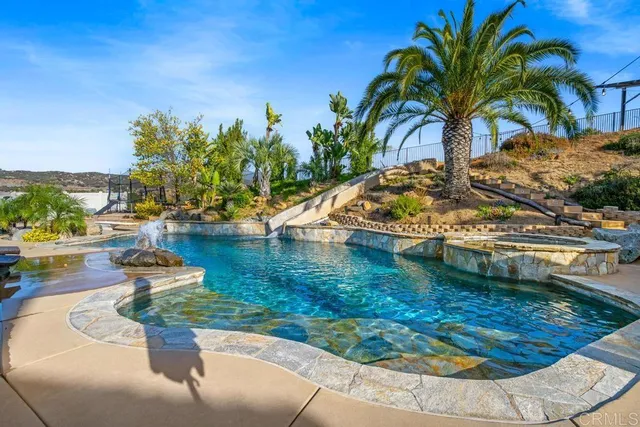 a living room with stainless steel appliances kitchen island granite countertop furniture and a kitchen view