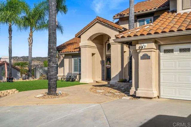 a view of a house with a small yard and plants