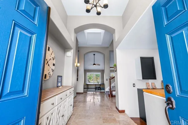 a living room with couches floor to ceiling window and a floor to ceiling window