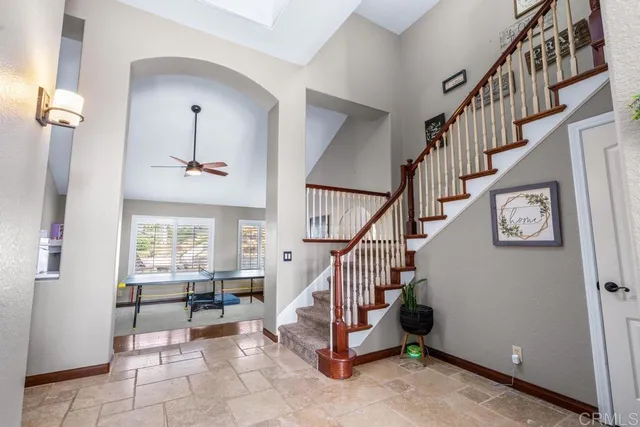 a view of a patio with table and chairs under an umbrella