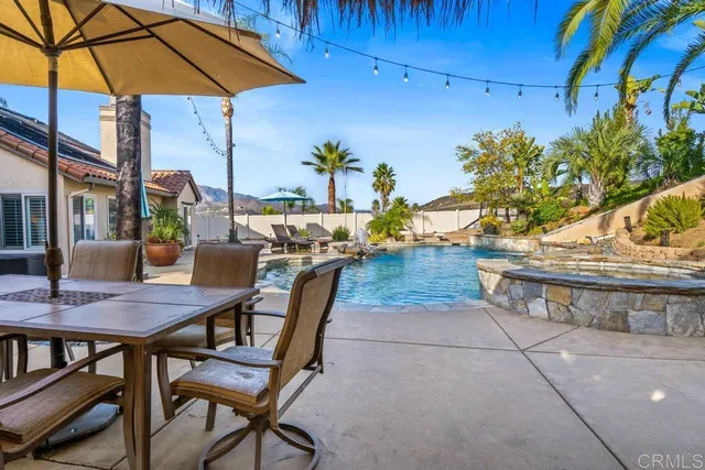 a front view of a house with garden and sitting area