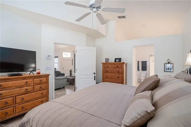 a bedroom with a bed and flat screen tv