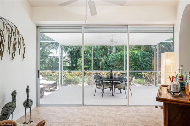 a patio with yard glass top table and chairs