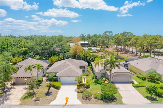 an aerial view of a house with garden space and ocean view