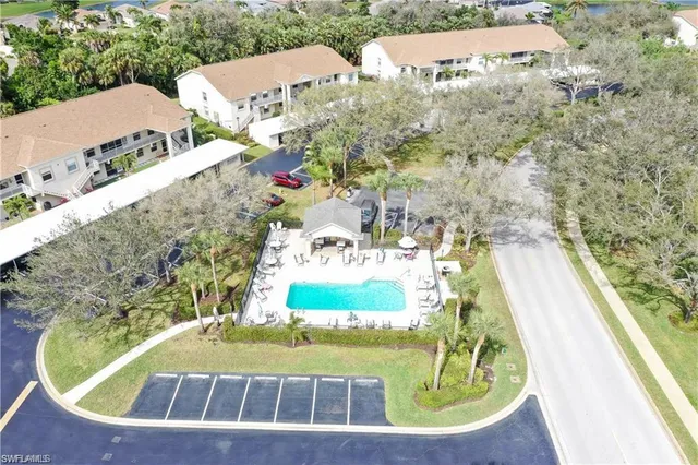 a outdoor view of house with swimming pool and furniture