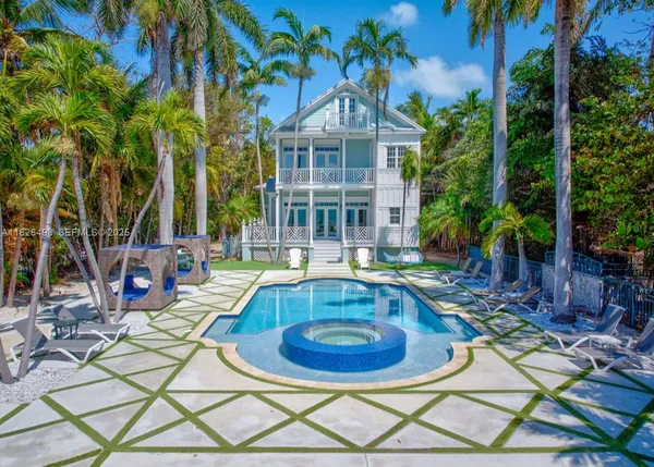 a view of a house with swimming pool and sitting area