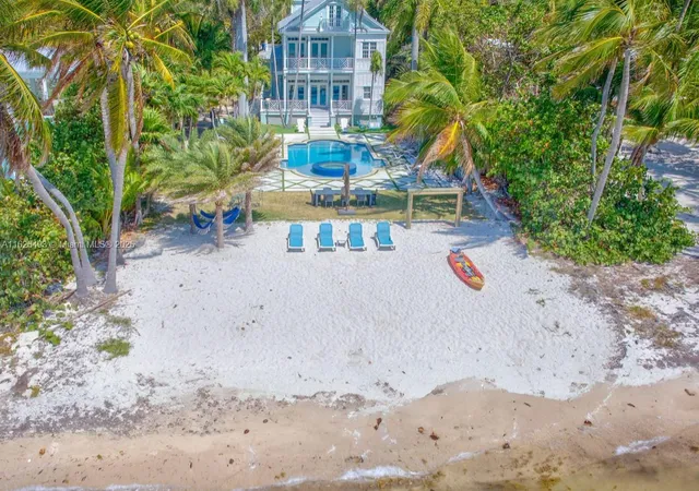 a view of a yard with plants and wooden fence