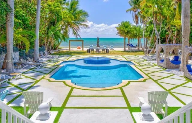 a ocean view with pool table and chairs