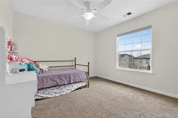 a spacious bedroom with a bed and a chandelier