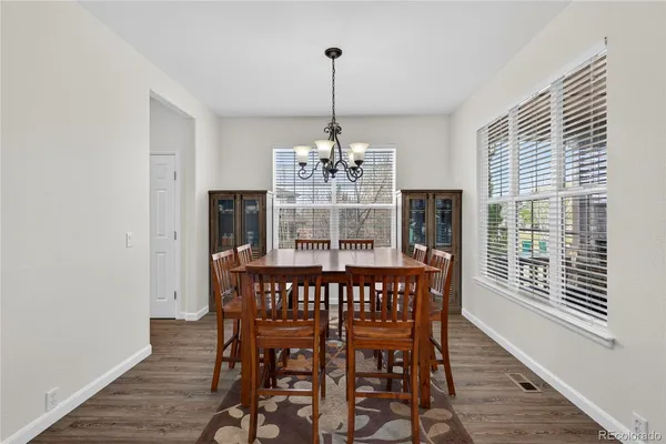 a view of a dining room with furniture window and wooden floor