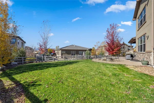 a front view of house with yard and outdoor seating
