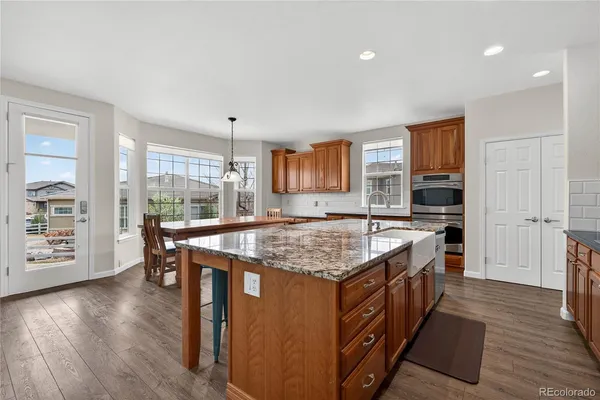 a kitchen with a stove and a wooden floor